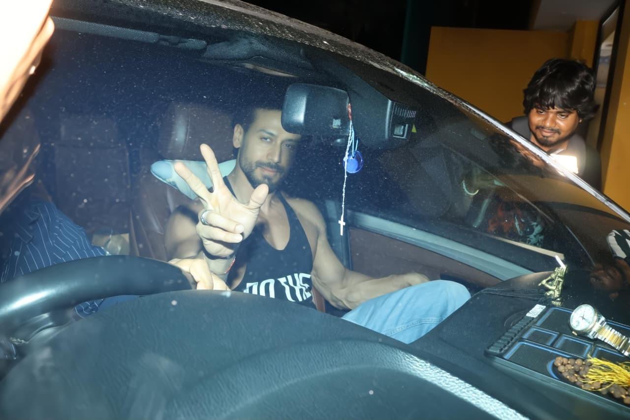 War actor Tiger Shroff also arrived for the special screening of the sequel of his film, War 2, in the city today, wearing a black vest as he waved at the paps from his car.